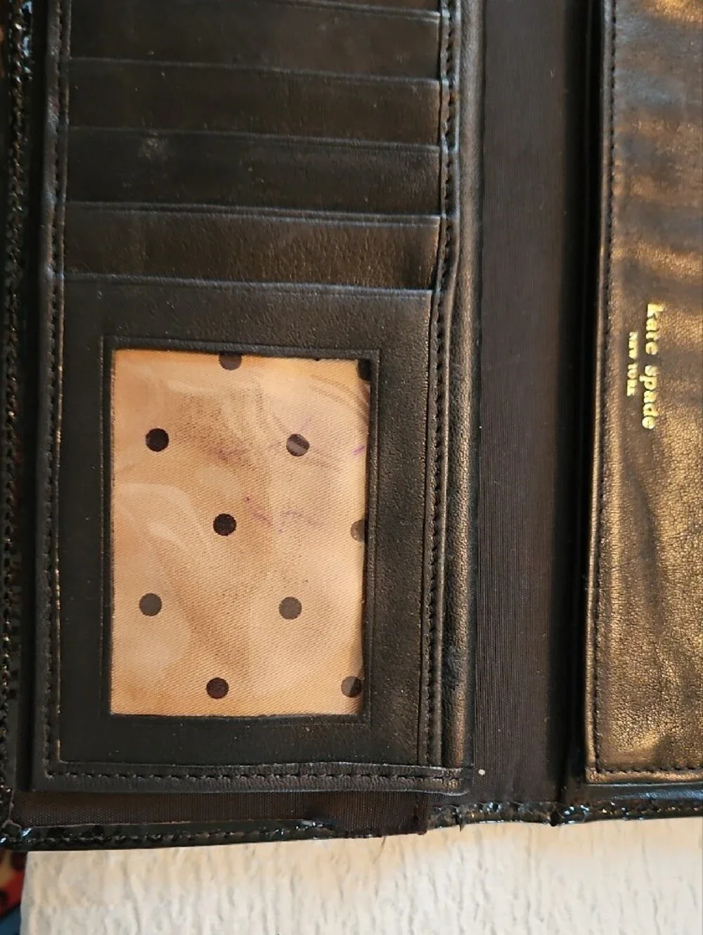 kate spade black wallet with gold-tone nameplate